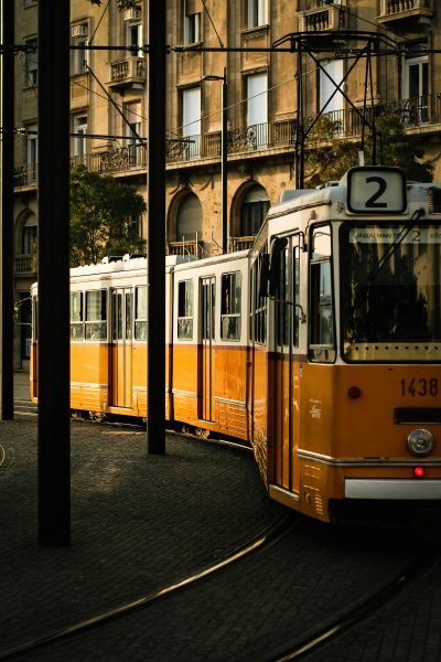 A classic yellow tram in Budapest's old town captures the essence of retro urban travel. A-classic-yellow-tram-in-Budapest's-old