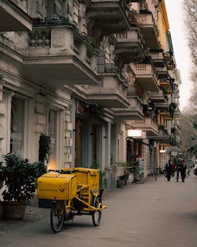 A picturesque view of a street in Kreuzberg, Berlin, featuring historic architecture and a Deutsche Post bicycle.