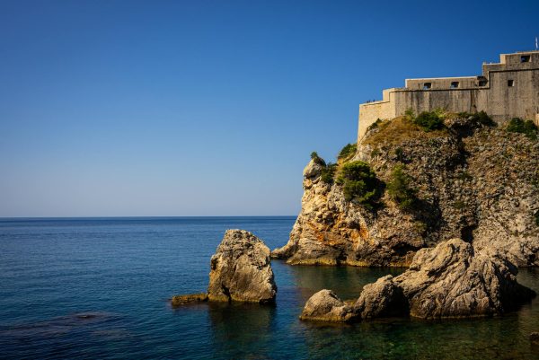 Scenic view of Fort Lovrijenac against a bright blue sky along the Adriatic Sea in Dubrovnik, Croatia. Scenic view of Fort Lovrijenac against a bright blue sky along the Adriatic Sea in Dubrovnik, Croatia.