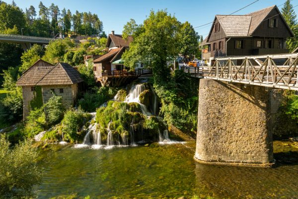 Idyllic view of a small waterfall and bridge in Slunj, Croatia.