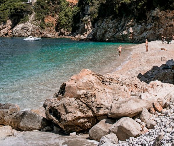 Picturesque beach scene with rocky shore and lush hills, perfect for a tranquil getaway. Picturesque beach scene with rocky shore and lush hills, perfect for a tranquil getaway.