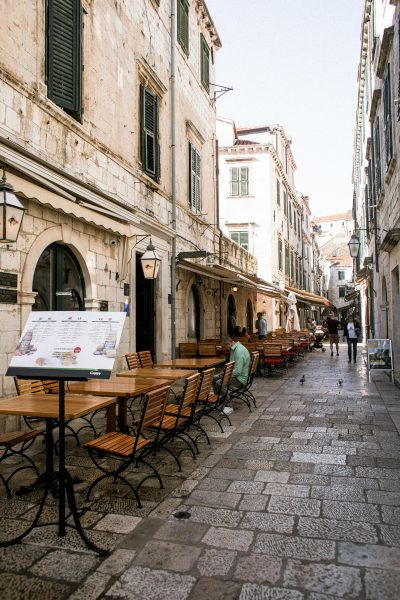 Explore the historic streets of Dubrovnik with charming outdoor cafés and classic architecture. Explore the historic streets of Dubrovnik with charming outdoor cafés and classic architecture.
