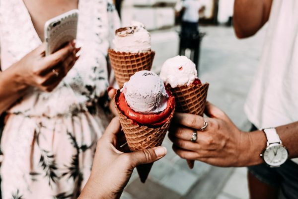 pexels-photo-4997886-4997886 Crop anonymous friends in casual summer clothes clinking delicious cone ice creams while gathering on street