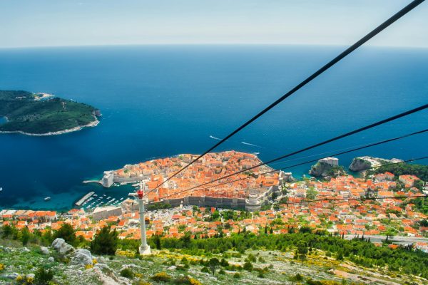 Stunning aerial view of Dubrovnik's historic old town and blue Adriatic Sea, highlighting the city's iconic architecture. Stunning aerial view of Dubrovnik's historic old town and blue Adriatic Sea, highlighting the city's iconic architecture.
