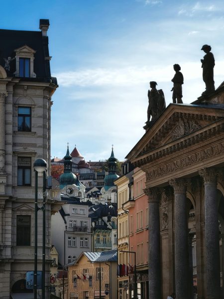 Stunning view of Karlovy Vary's historic architecture with diverse buildings and sculptures. Stunning view of Karlovy Vary's historic architecture with diverse buildings and sculptures.