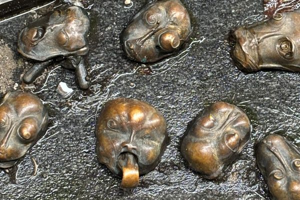 Bronze faces with expressive features mounted along the narrow cobblestone Alleyway of Faces in Ljubljana Old Town. The surreal art installation by sculptor Jakov Brdar transforms the historic alley into one of the city’s most unusual and immersive public artworks.