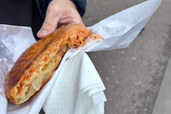 Slovenian burek filled with pizza style toppings layered between crispy flaky pastry and served as a popular street food snack. The savory pastry is a local favorite known for its rich filling and golden crust.